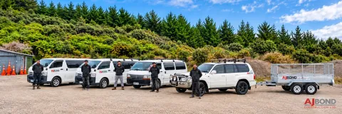 The AJ Bond Construction team with their branded work vehicles